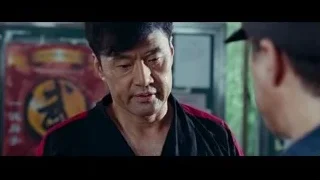 man in black and red jacket smiling — The Karate Kid