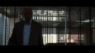man in suit at office desk — Batman: The Dark Knight Rises