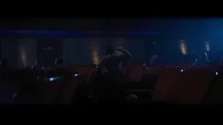 man in suit in dimly lit movie theater — La La Land