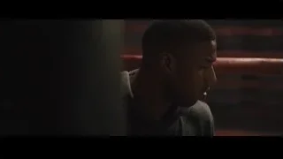 Man's face in grey hoodie looking serious — Creed 2