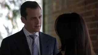 Man and woman standing by brick wall — Suits