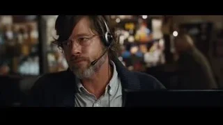 man with headset working on laptop — The Big Short