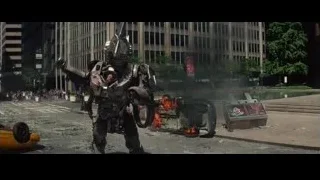 Robot holding gun on city street — The Amazing Spider Man 2