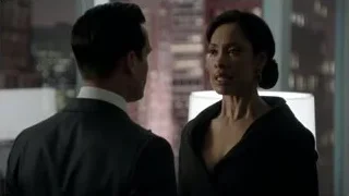 man and woman facing each other with city skyline — Suits