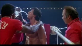 shirtless man in boxing ring with trainers — Rocky III