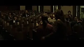 woman giving presentation in dim auditorium — Fight Club