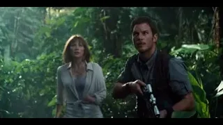 man with gun and woman in jungle — Jurassic World