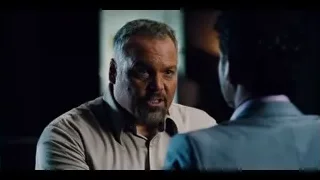 two men conversing in dimly lit room — Jurassic World