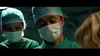 two surgeons in operating room with patient — Lucy