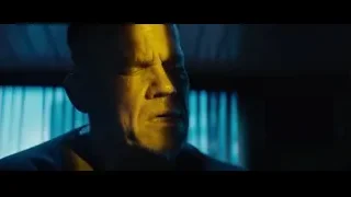 Man's face in blue lit dark room — Deadpool 2