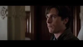 man's serious face in dimly lit room — Batman