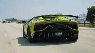 yellow sports car on highway with BROLY plate — Sports Cars