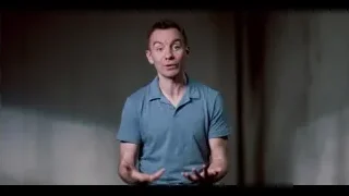 man speaking in dimly lit room — The Social Dilemma