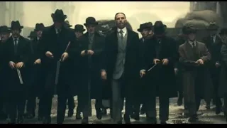 men in suits with guns walking on street — Peaky Blinders