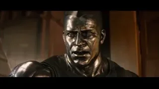 bronze statue of man in black suit — Deadpool 2