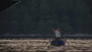 Two people in small blue boat — Succession