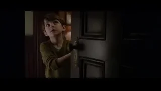 young boy holding dark door handle — The Amazing Spider Man
