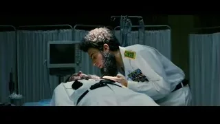Man in lab coat examining medical device — The Dictator
