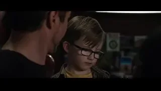 Father about to kiss son in dimly lit room — Iron Man 3