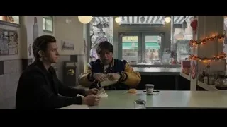 two young men conversing at restaurant table — Spiderman: No Way Home