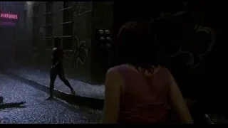 woman standing in rainy alleyway at night — Spider Man