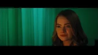 young woman with serious expression by green curtain — La La Land