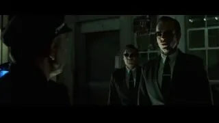 three men in dark room with police officer — The Matrix