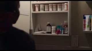 woman looking in mirror in bathroom — The Bear
