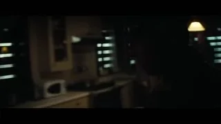 Person looking out window in dimly lit room — Interstellar