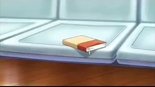Red hardcover book on wooden surface — I Want To Eat Your Pancreas