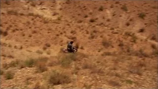 Person riding dirt bike on dry hillside — Breaking Bad