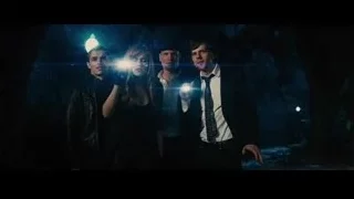 three people with gun in dark blue lit room — Now You See Me