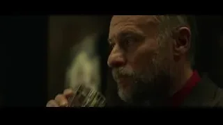 man with beard drinking from glass — John Wick