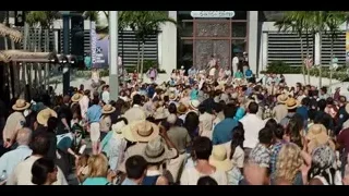 large crowd walking on busy street — Jurassic World