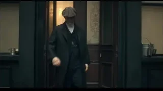 man in suit holding gun in dark hallway — Peaky Blinders