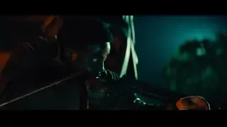 Man holding chainsaw in dark forest — John Wick: Chapter 4