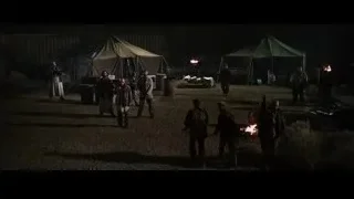 people gathered around campfire at night — Iron Man