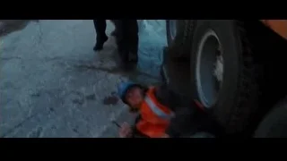 construction worker holding dog at site — Batman: The Dark Knight Rises