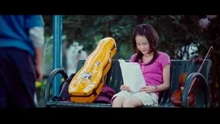 young girl sitting on park bench with violin — The Karate Kid