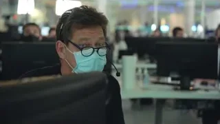 man in face mask focused on computer in office — Elon Musk: Return to Space
