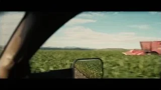 red combine harvester harvesting crops in field — Interstellar