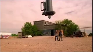 two men walking in desert with crane — Breaking Bad