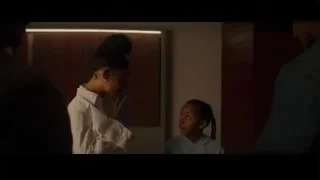 young girl looking at man in dimly lit room — Creed 3