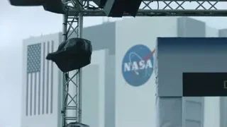 black object hanging from NASA structure — Elon Musk: Return to Space