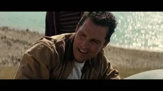 Man smiling sitting on bench by ocean — Interstellar