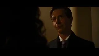 man in suit standing in dimly lit room — Batman: The Dark Knight Rises