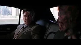 Man in suit sitting in car looking out window — Batman: The Dark Knight
