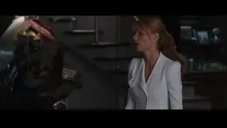 Woman in white blazer standing near robot — Iron Man 3
