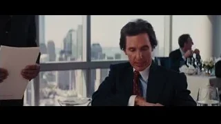Man in suit at restaurant with city view — The Wolf Of Wall Street