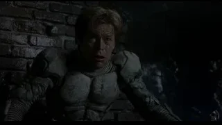 man in military outfit lying on ground — Spider Man
